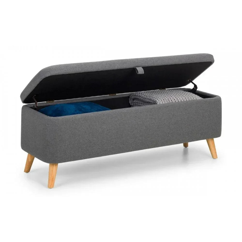 Grey fabric storage bench with open lid, showing blue cushion and folded blanket inside