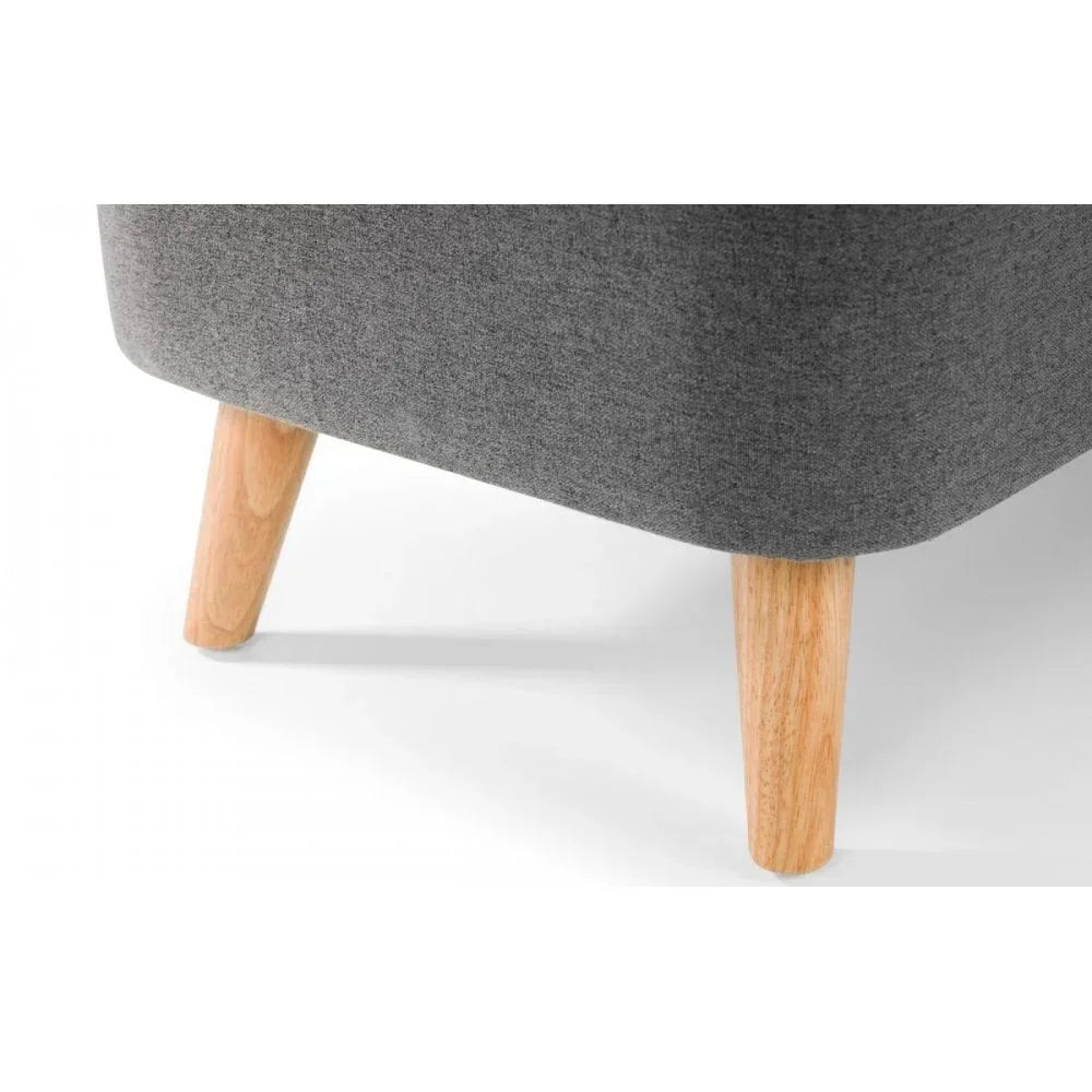 Close up of grey fabric sofa corner with light wooden legs