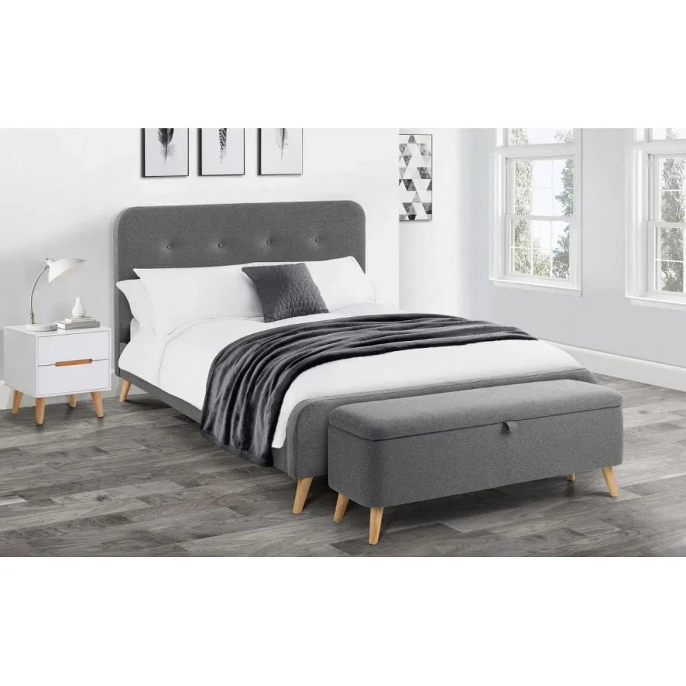 Grey upholstered bed with buttoned headboard, matching bench and nightstand in modern bedroom