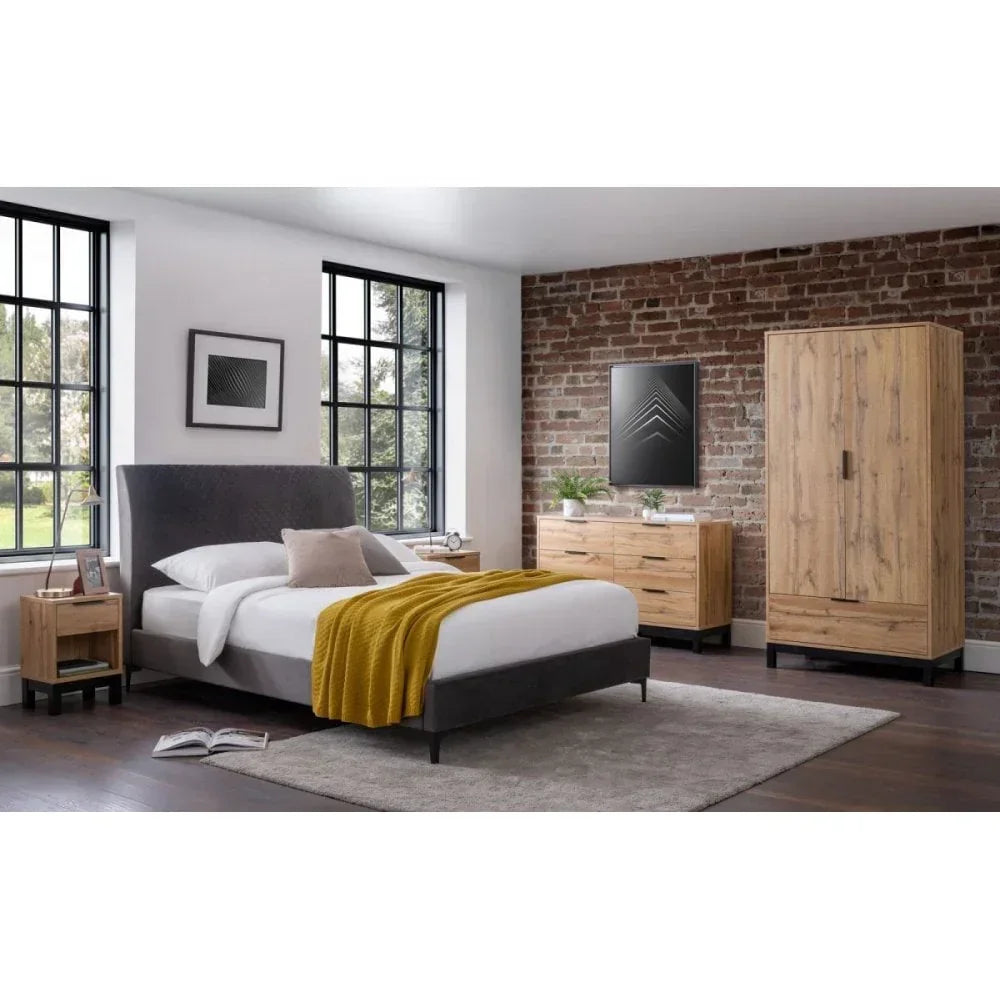 Modern bedroom set with grey upholstered bed, wood wardrobe, chest of drawers, and side table