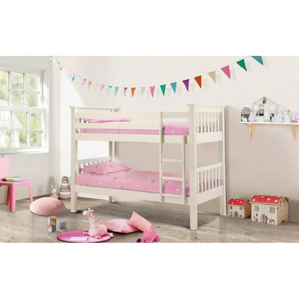 White wooden bunk bed with ladder and pink bedding in a bright children's bedroom