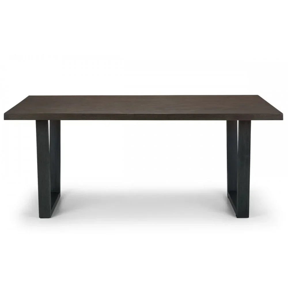 Rectangular dark wood dining table with angled legs and modern design