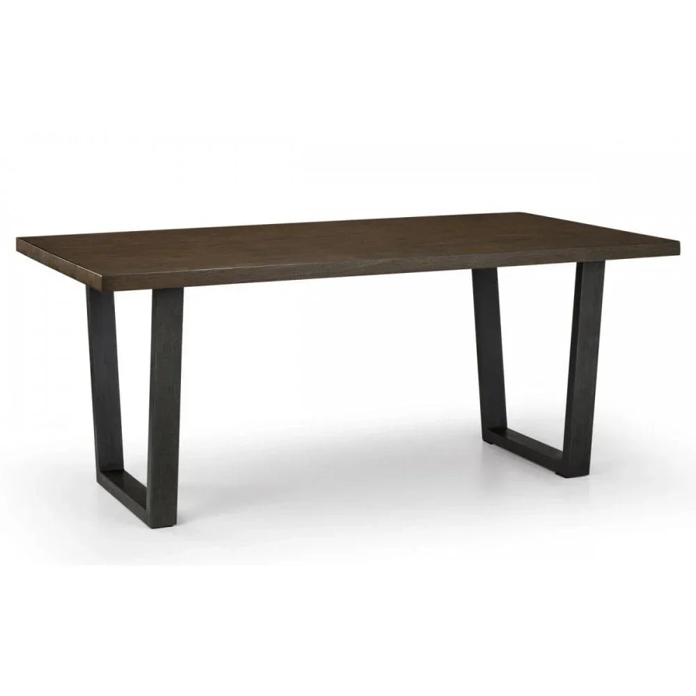 Rectangular wooden dining table with dark metal legs on a white background