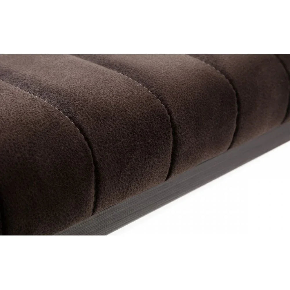 Closeup of brown upholstered sofa seat with vertical stitched channels