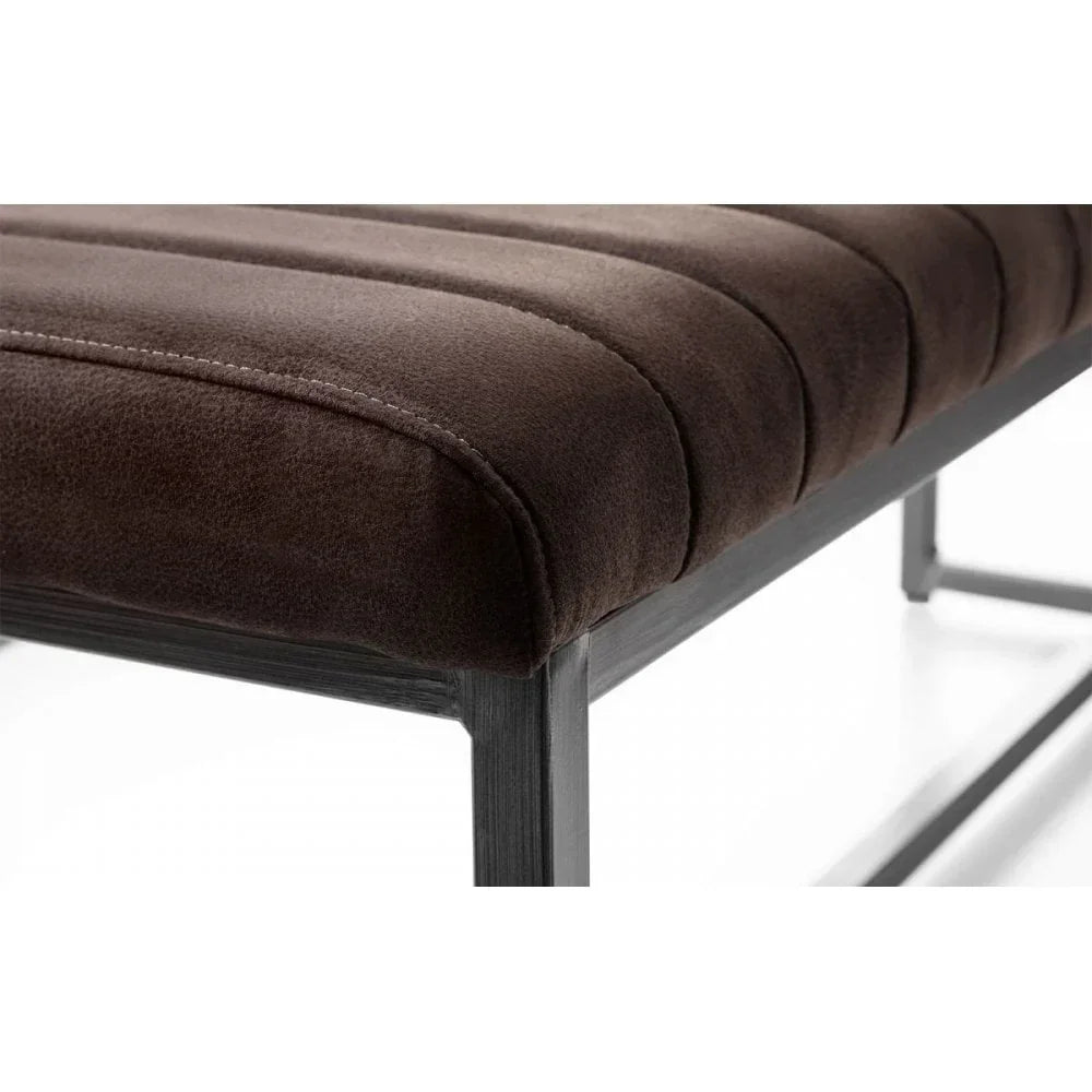 Brown upholstered dining bench seat with stitched detail and black metal frame close-up