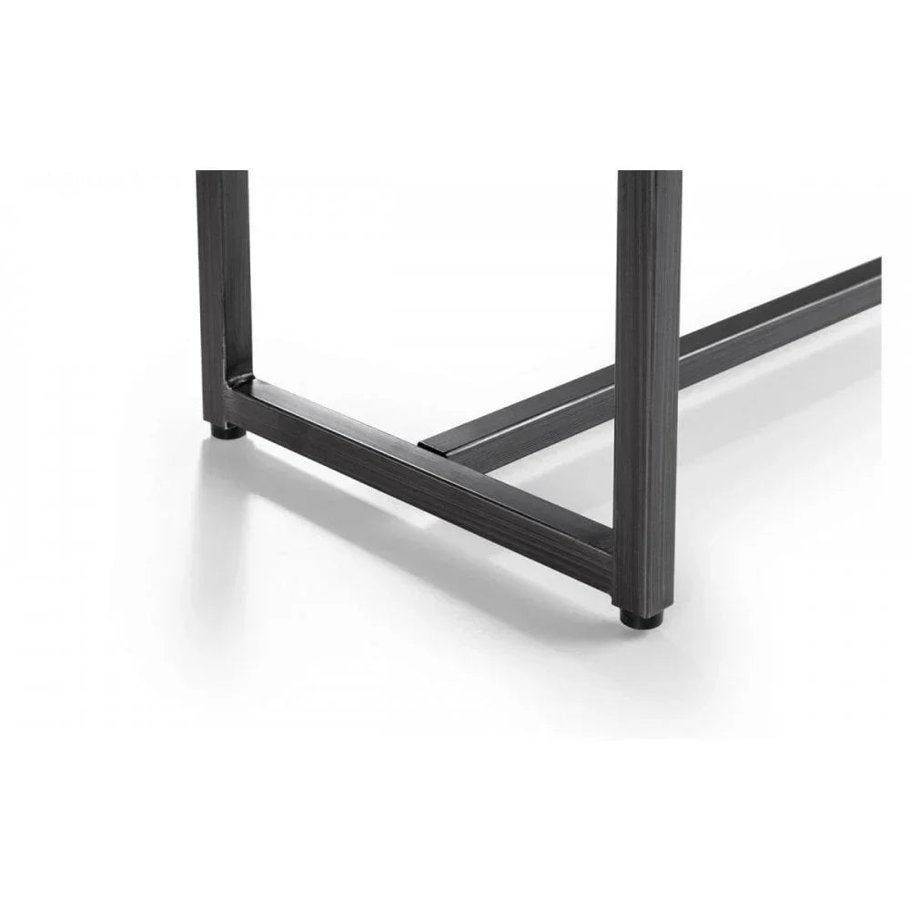 Close view of black metal table legs and frame on white floor