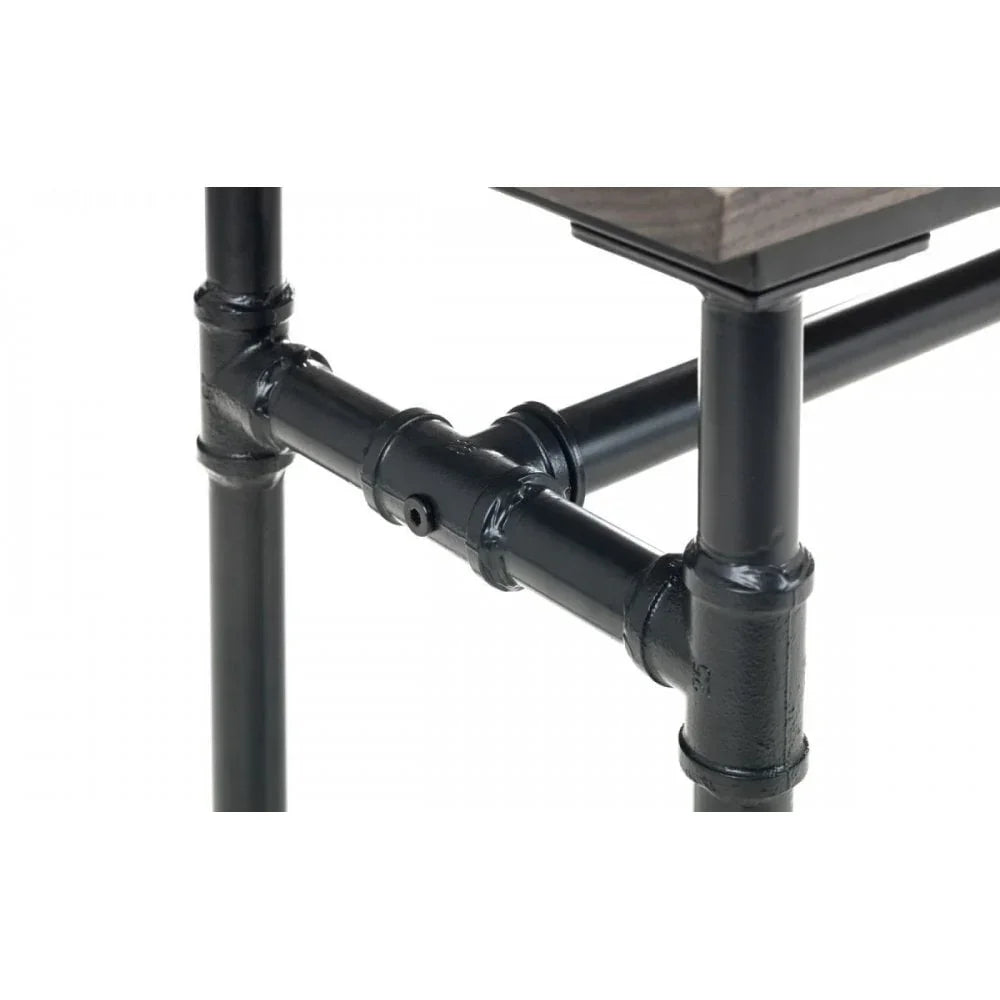 Black metal table legs with pipe joint detail and wood tabletop corner close-up