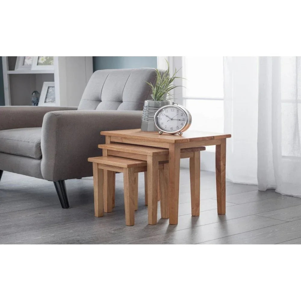 wooden nesting tables set beside grey armchair in modern living room