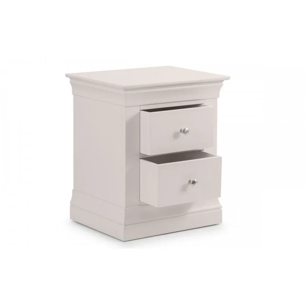 White bedside table with two drawers, silver knobs, classic moulded edges, angled view