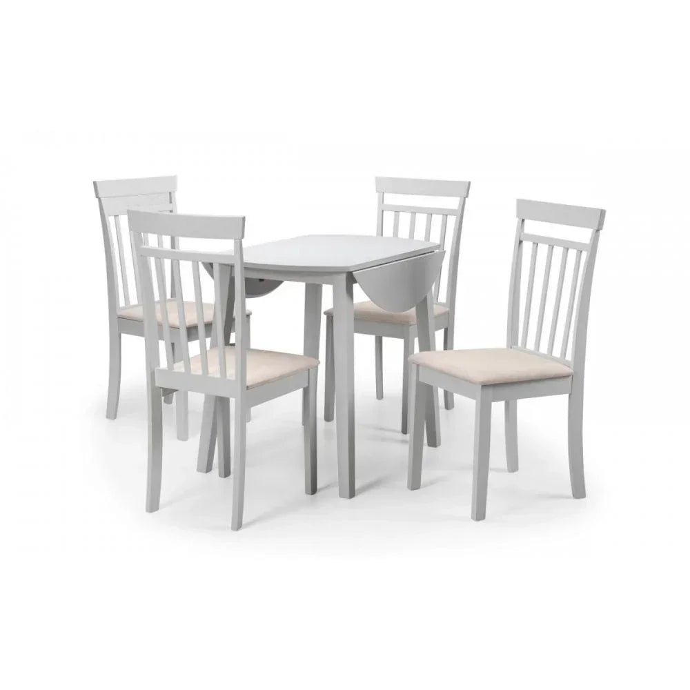 White wooden dining table set with four chairs and cushioned seats on white background