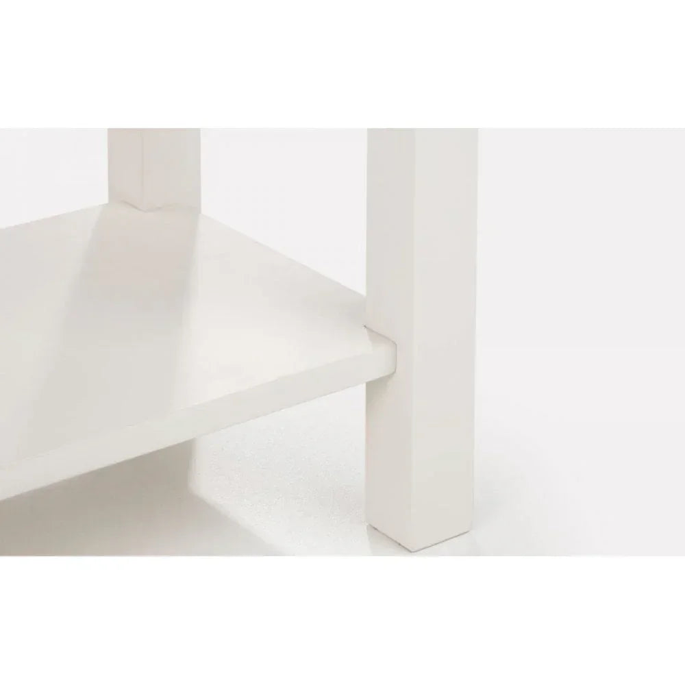 Close up of white wooden table leg and lower shelf with smooth finish