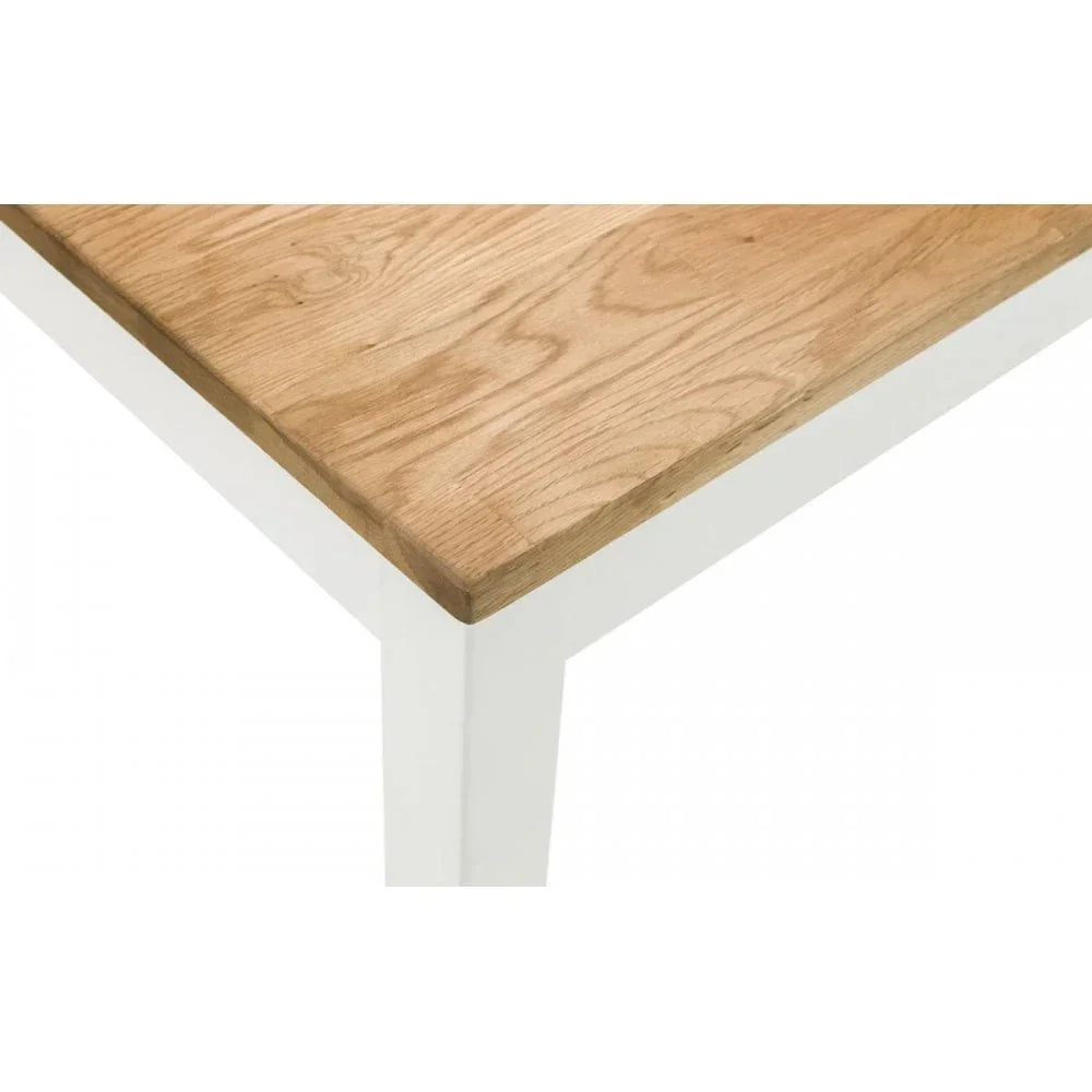 Oak dining table corner with natural wood top and white painted legs