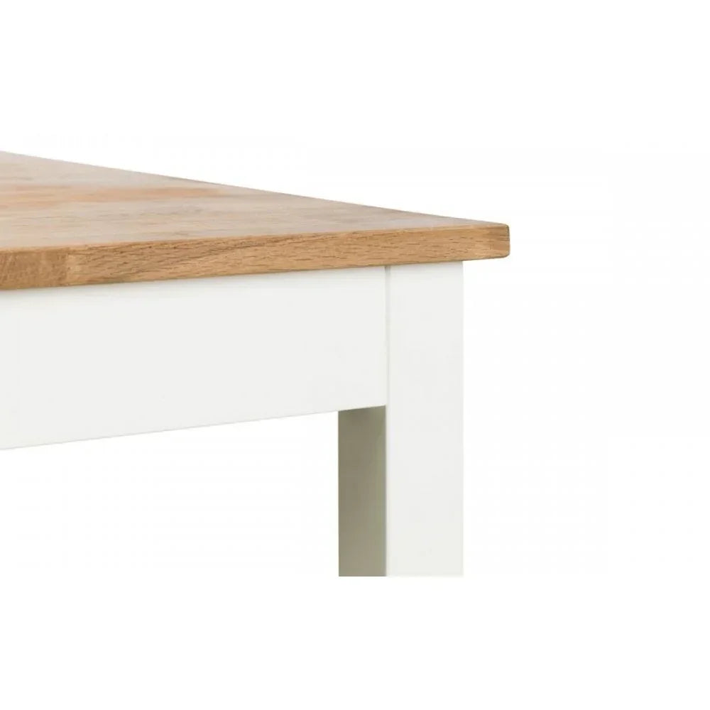 Close view of white dining table with light oak wood tabletop and square legs