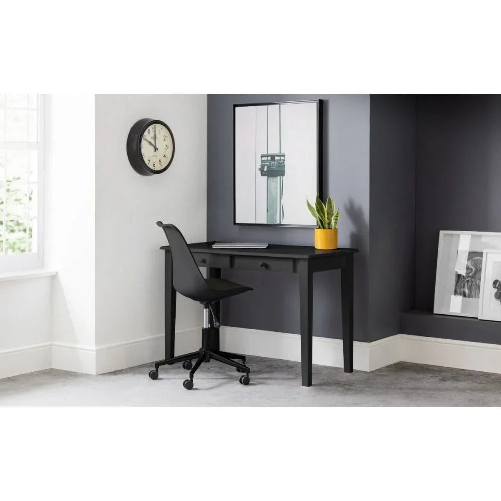 Black home office desk with drawer, paired with black chair and yellow plant pot