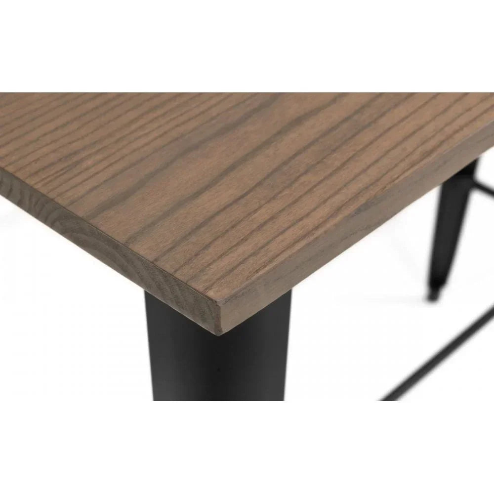 Close-up of wooden dining table corner with black metal legs