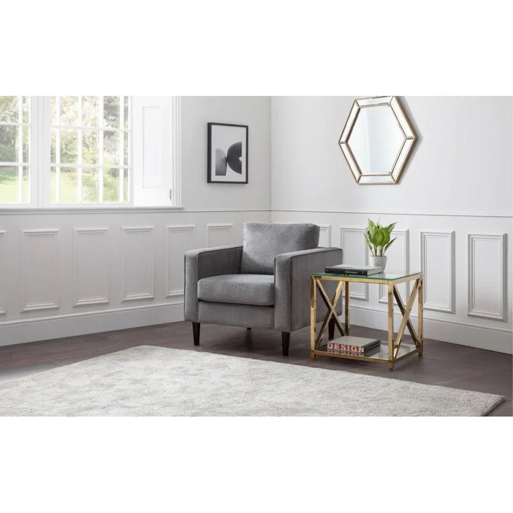 Grey velvet armchair with gold glass side table in modern living room