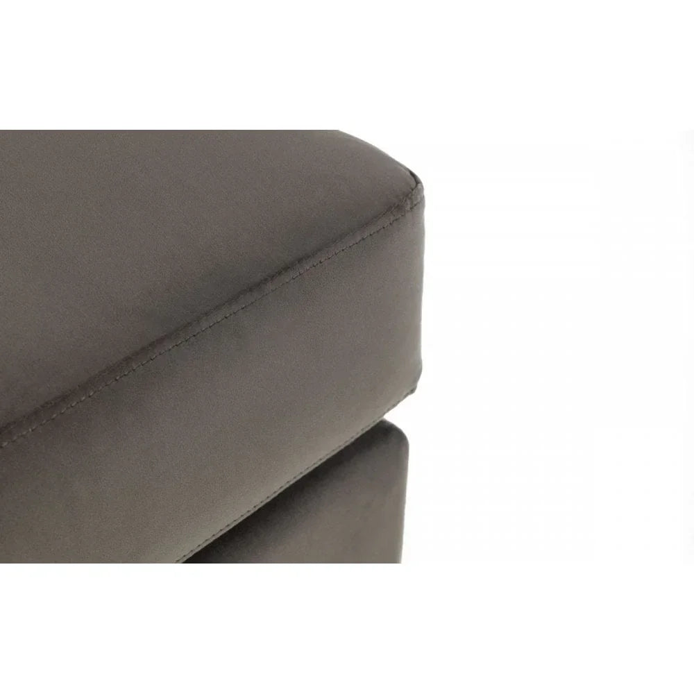 Closeup of grey fabric ottoman corner with visible stitching detail