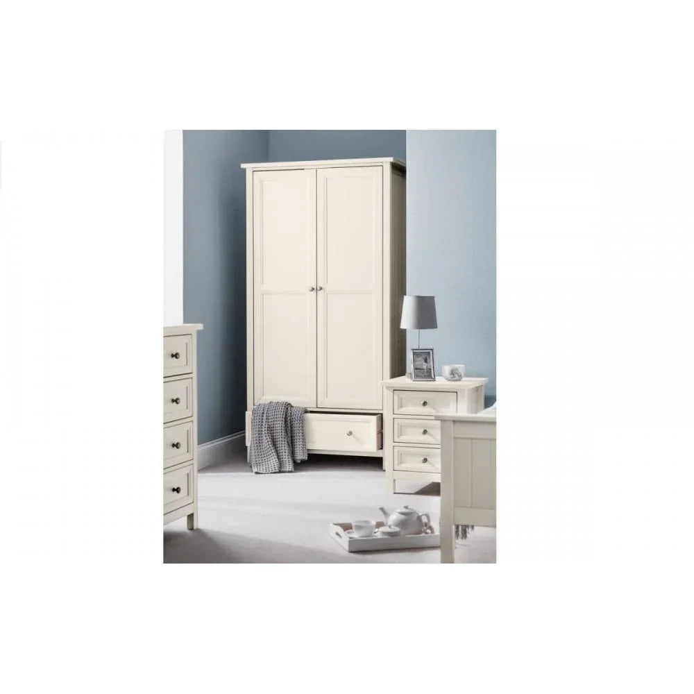 Cream bedroom wardrobe with drawer, matching bedside table, and drawers against blue wall