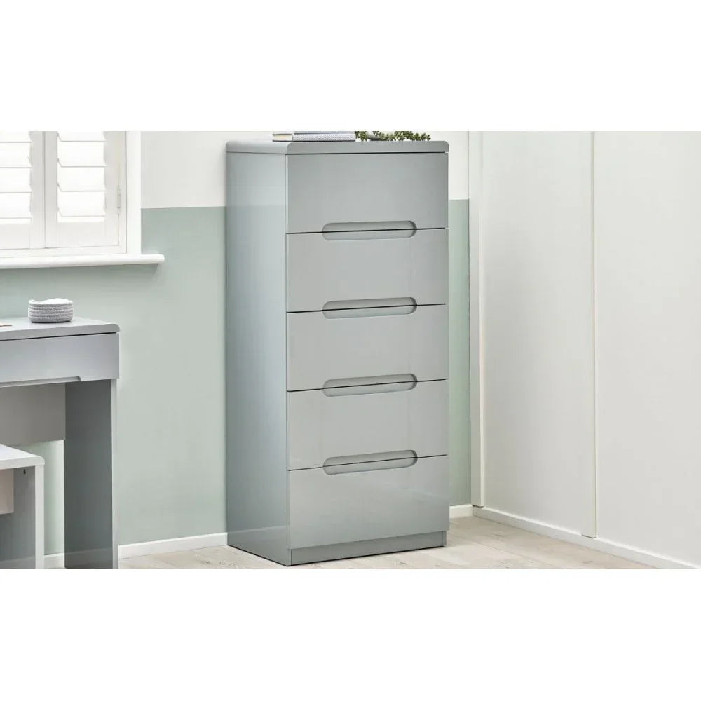 Grey gloss chest of drawers with four handles in a modern bedroom corner