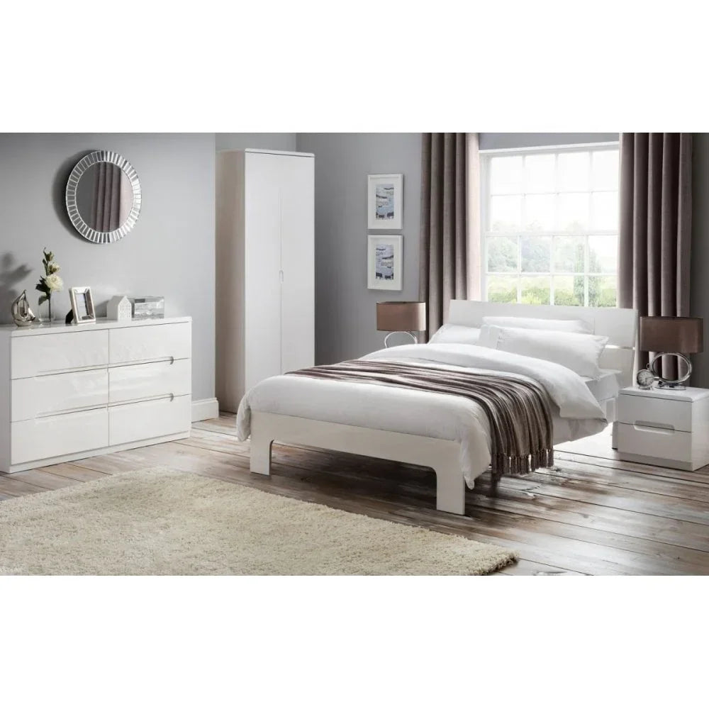 White bedroom furniture set with bed, wardrobe, drawers and two bedside tables in modern room