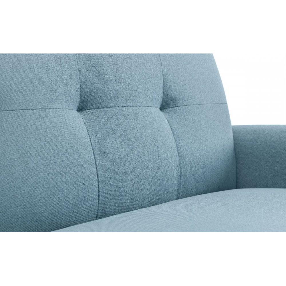 Close up of blue fabric sofa backrest with tufted upholstery and cushioned armrest