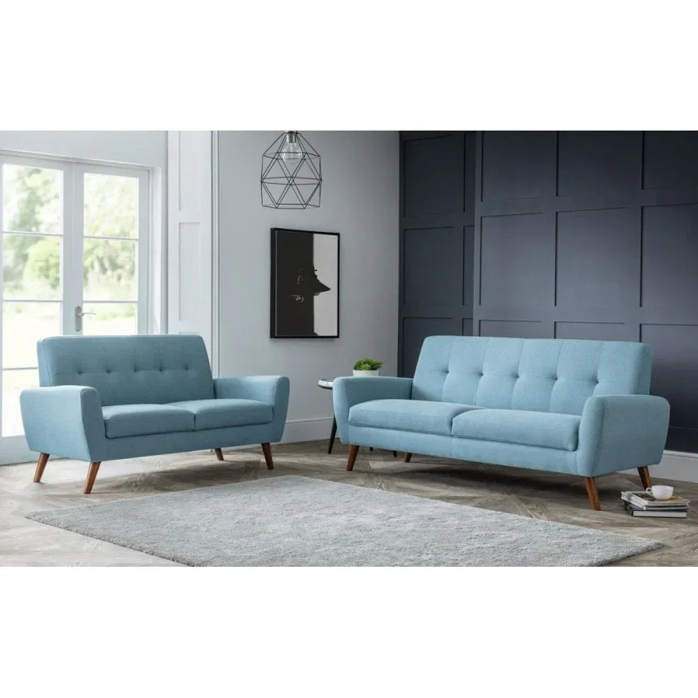 Light blue fabric sofa set with wooden legs in modern living room with grey rug