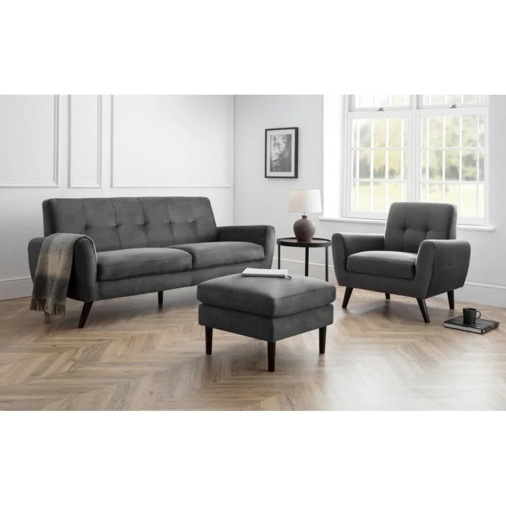 Grey fabric sofa set with armchair and footstool in bright living room with wood flooring