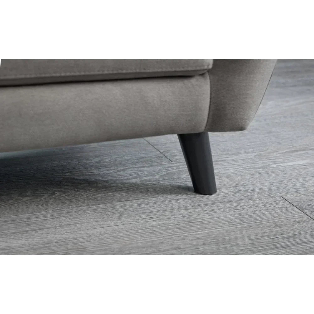 Grey fabric sofa corner with black angled leg on wood floor