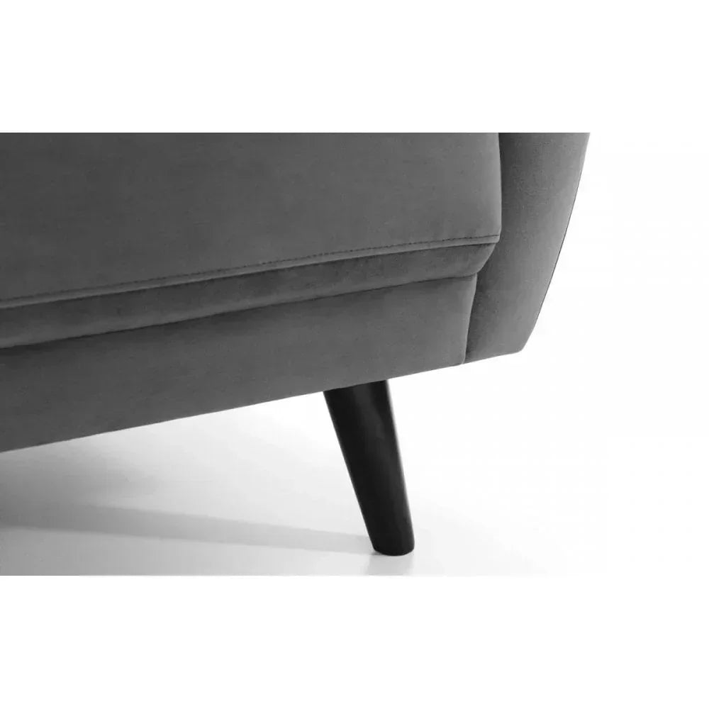 Close-up of grey sofa upholstery and black wooden leg