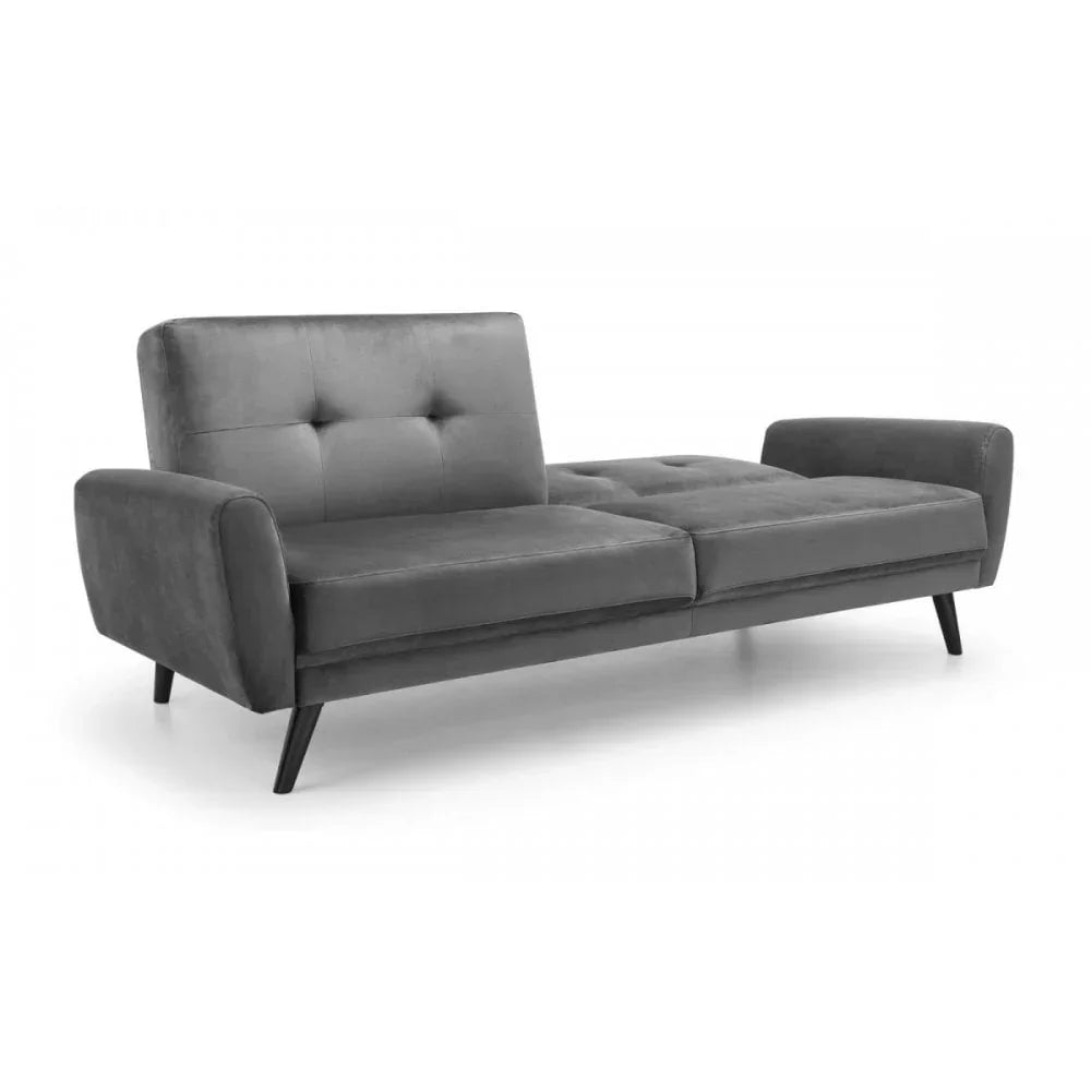 Grey velvet sofa bed with button tufted backrest and angled legs, shown in open position