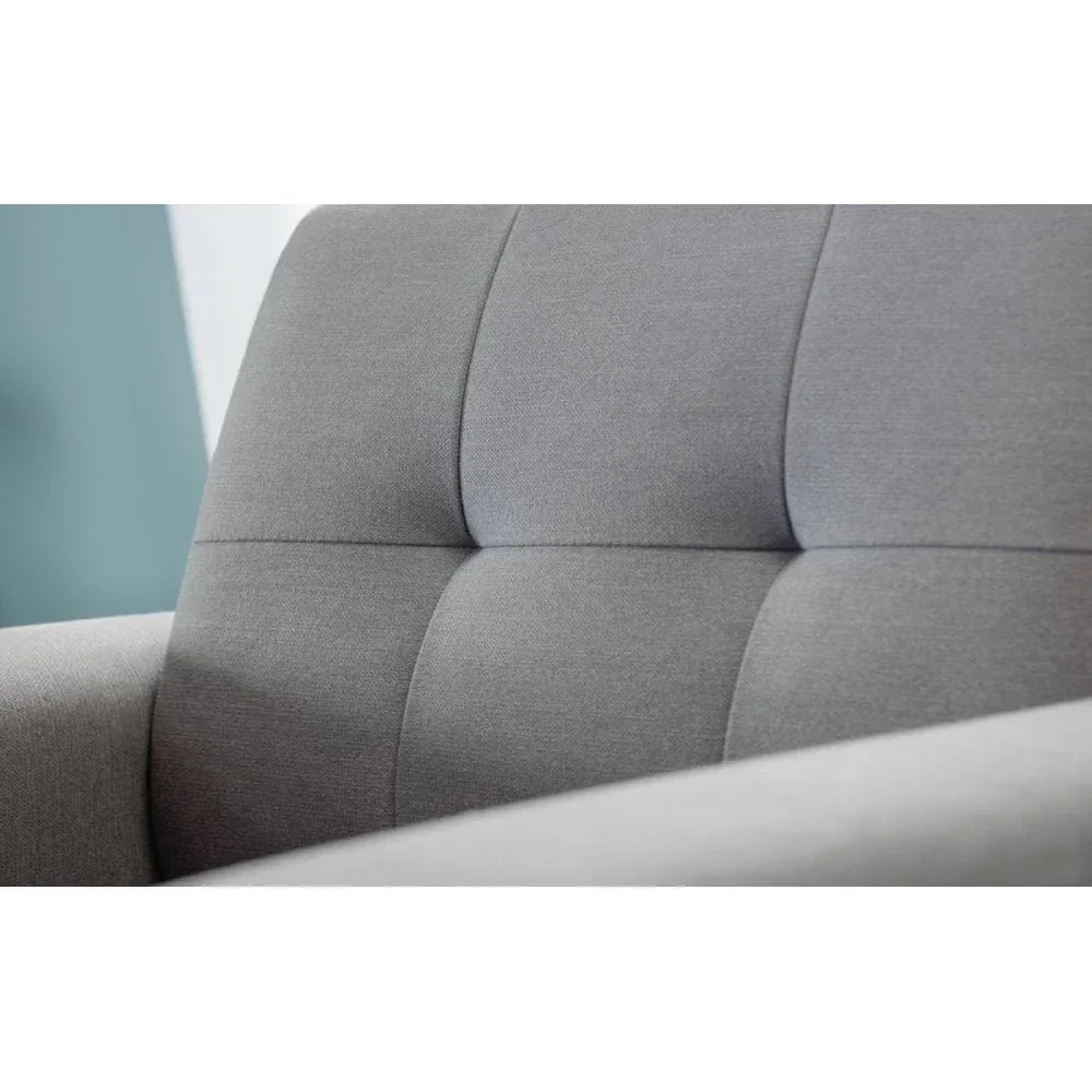 Closeup of grey fabric sofa backrest with stitched panel detail