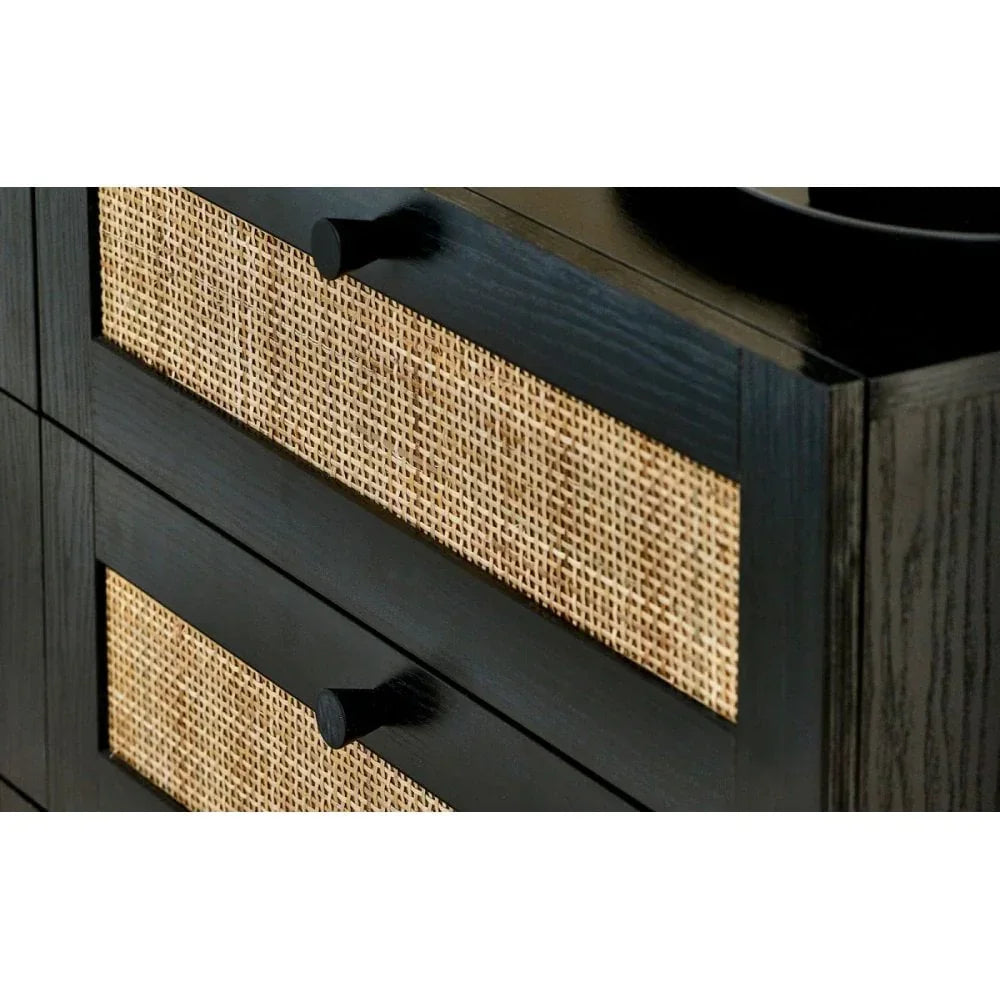 Black wood chest of drawers with rattan front panels and round handles, close-up view