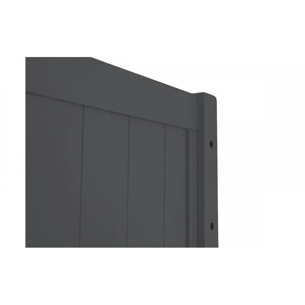 Closeup of dark grey wooden bed frame headboard corner with panel detailing