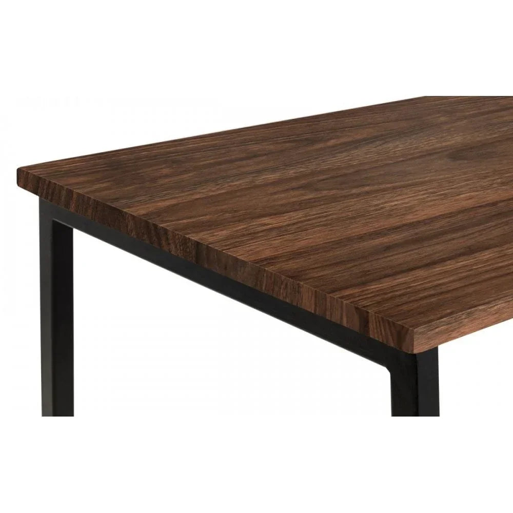 Rectangular wooden dining table with black metal legs, close-up of tabletop corner