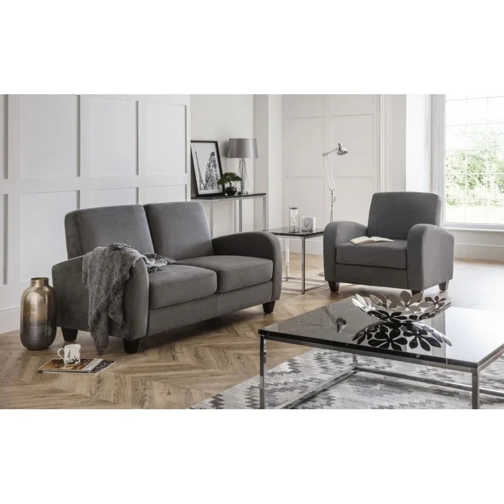 Grey fabric sofa and armchair set in a modern living room with glass coffee table