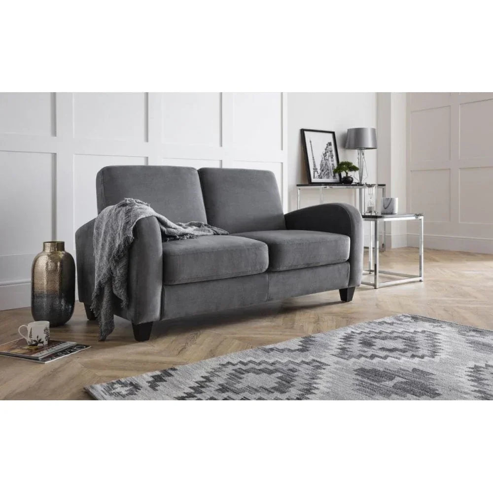 Grey fabric two seater sofa with throw, modern living room setting, patterned rug in foreground
