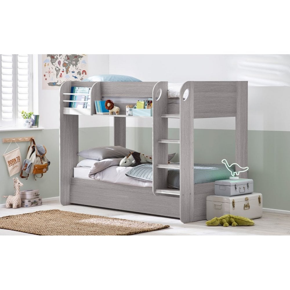Grey wooden bunk bed with ladder in children’s bedroom, plush toys and books on shelves