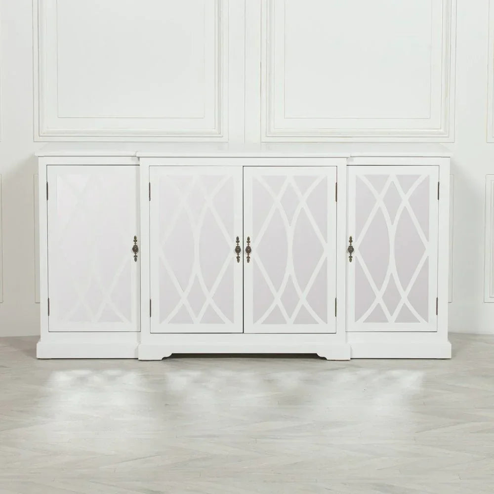 White four-door sideboard with geometric panel design and metal handles on light wood floor