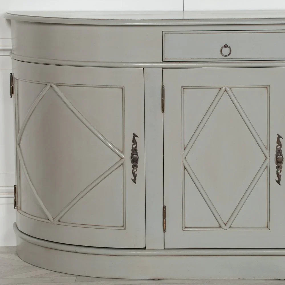 Grey wooden sideboard cabinet with diamond patterned doors and brass handles