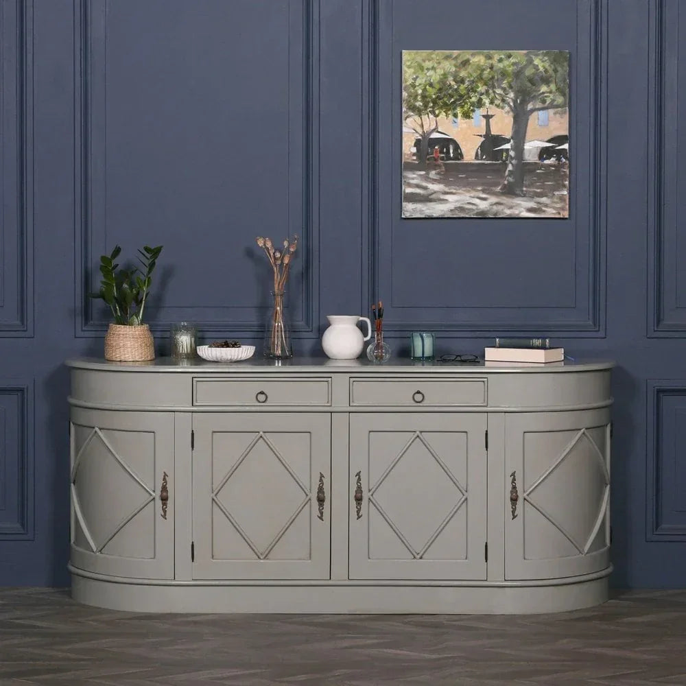 Grey sideboard cabinet with diamond panel doors against blue wall, decor items on top