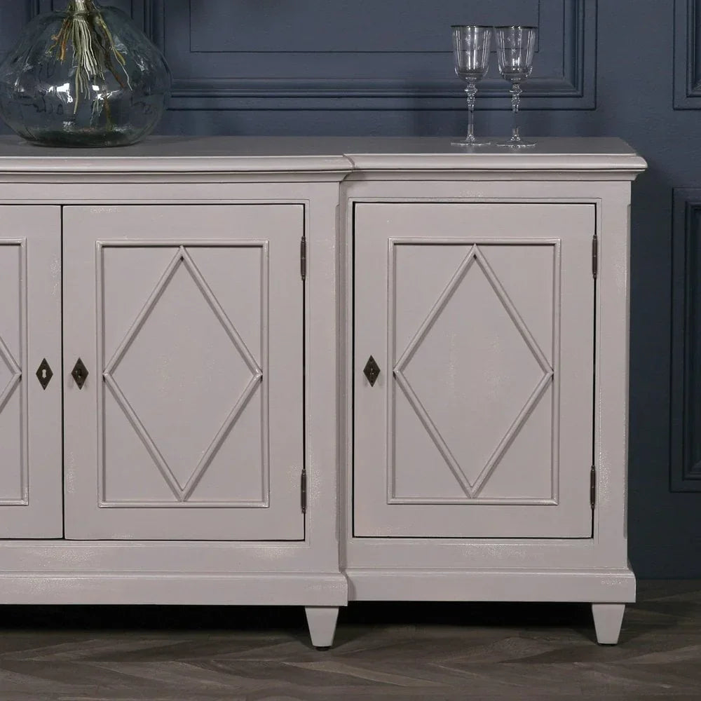 White sideboard cabinet with diamond detail doors, set against a navy panel wall