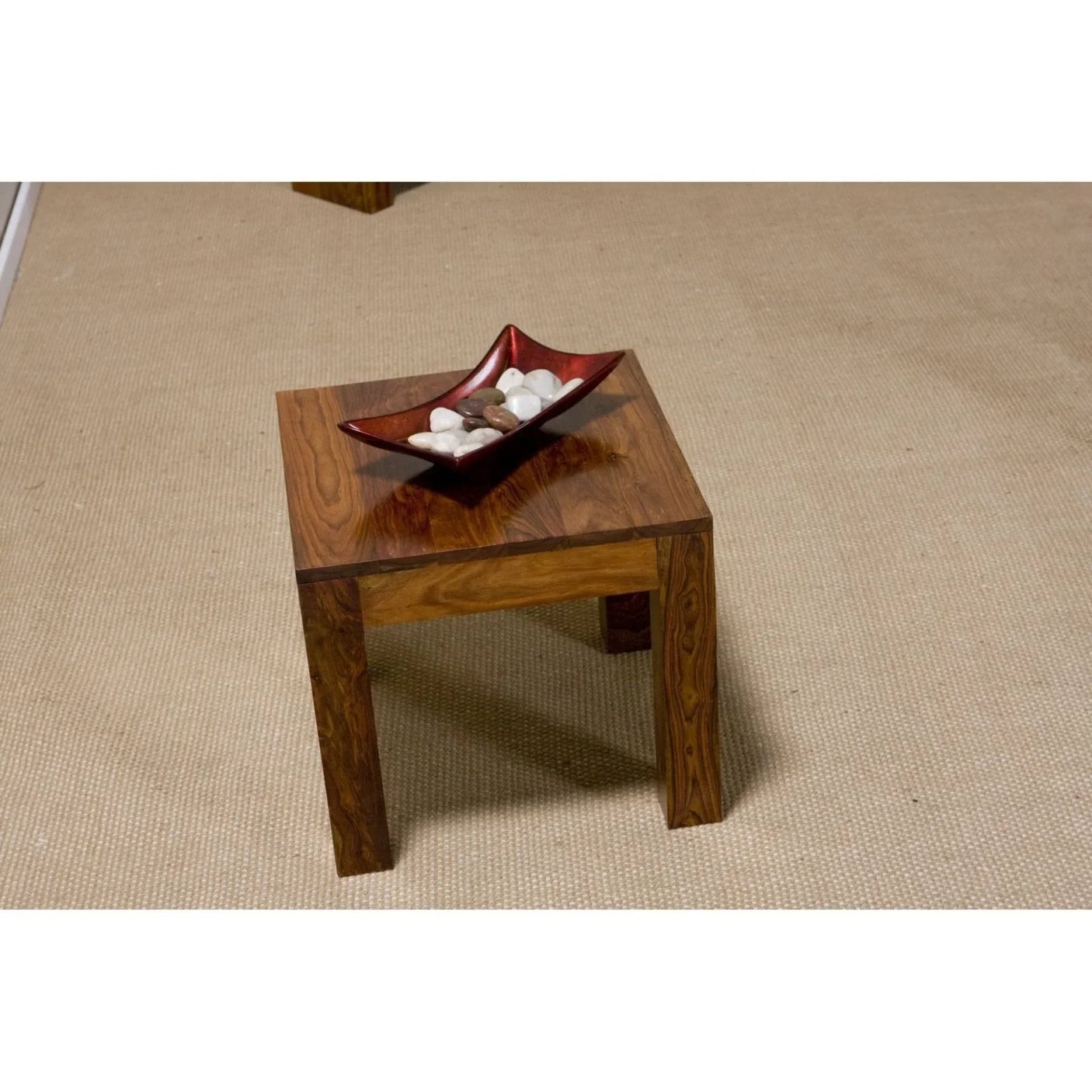 Square wooden side table with decorative bowl on beige carpet