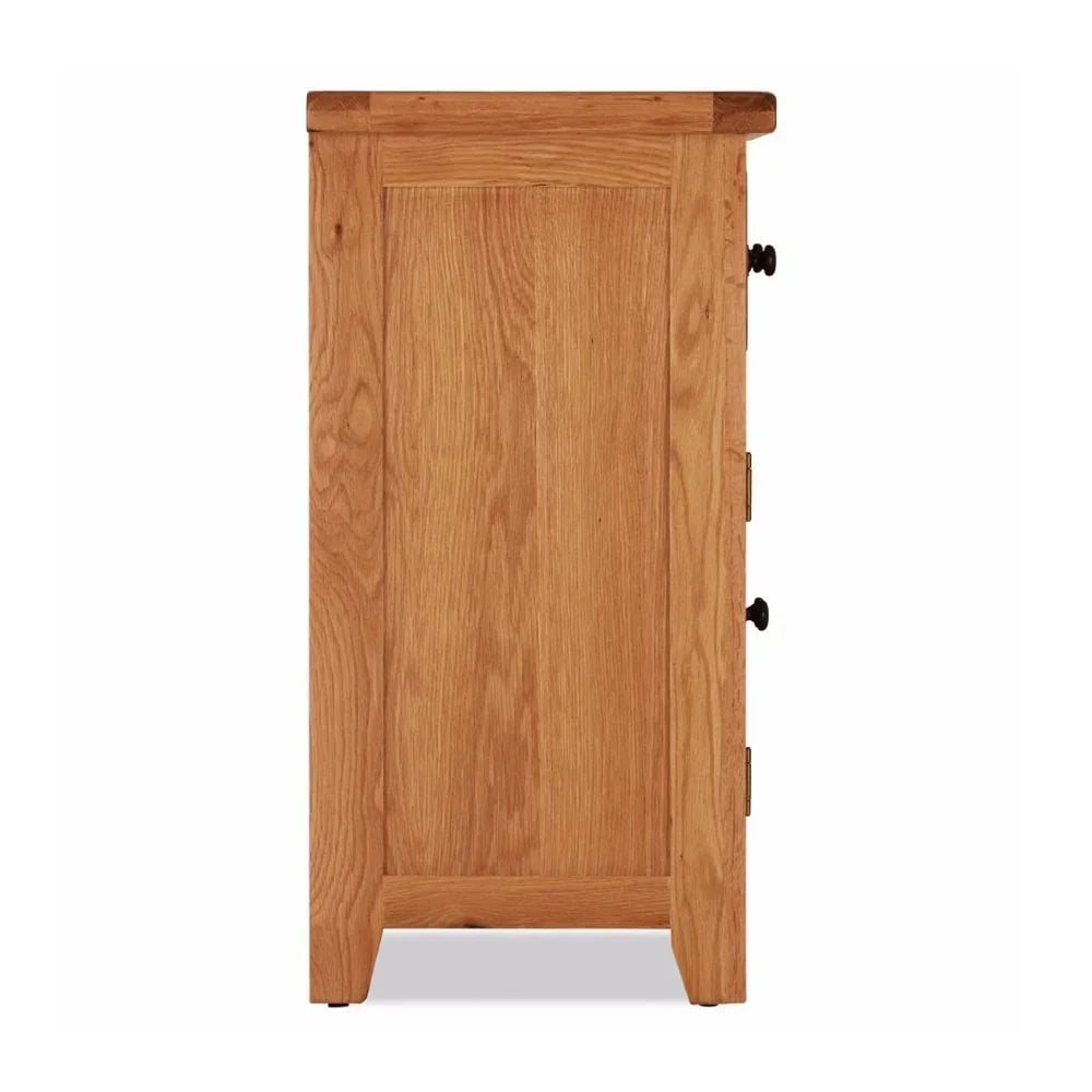 Side view of oak cabinet with wood grain finish and black metal drawer handles