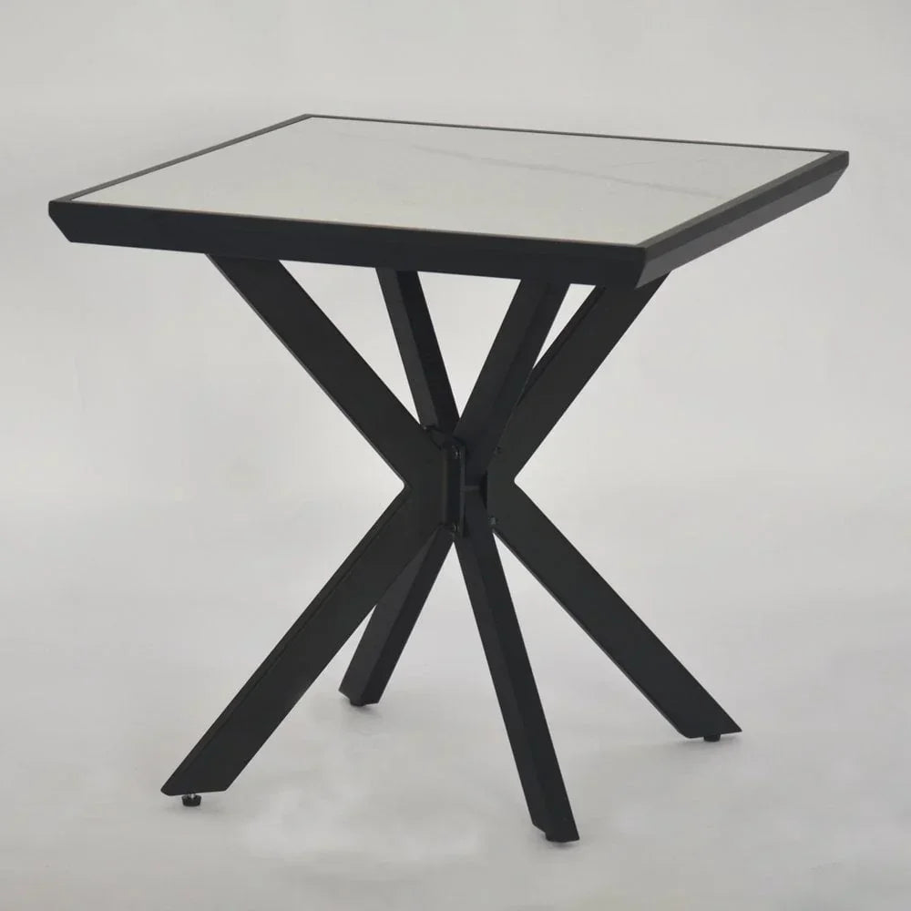 Square glass top dining table with black metal X frame base on white background