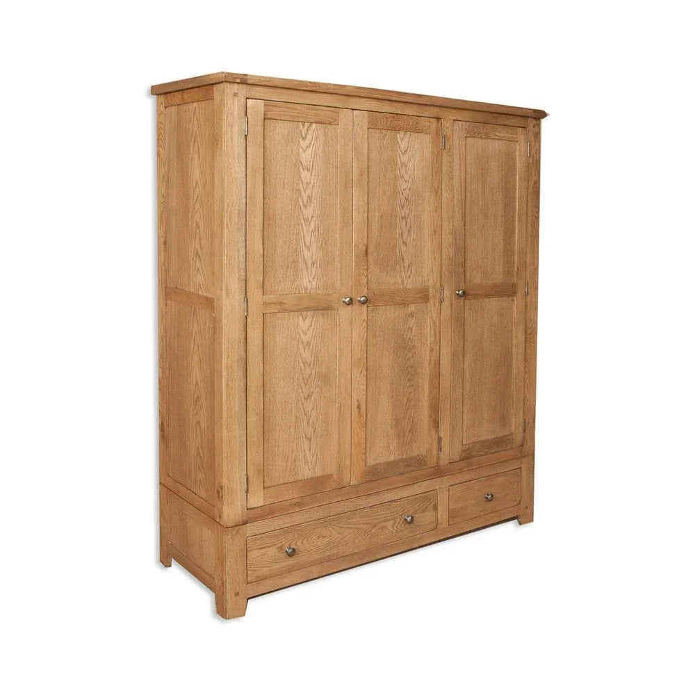 Oak wardrobe with three doors and lower drawers, panelled design, angled front view