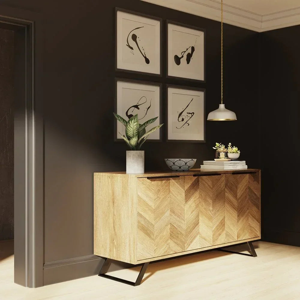 Chevron wood sideboard with metal legs in hallway, decorated with plant and art prints