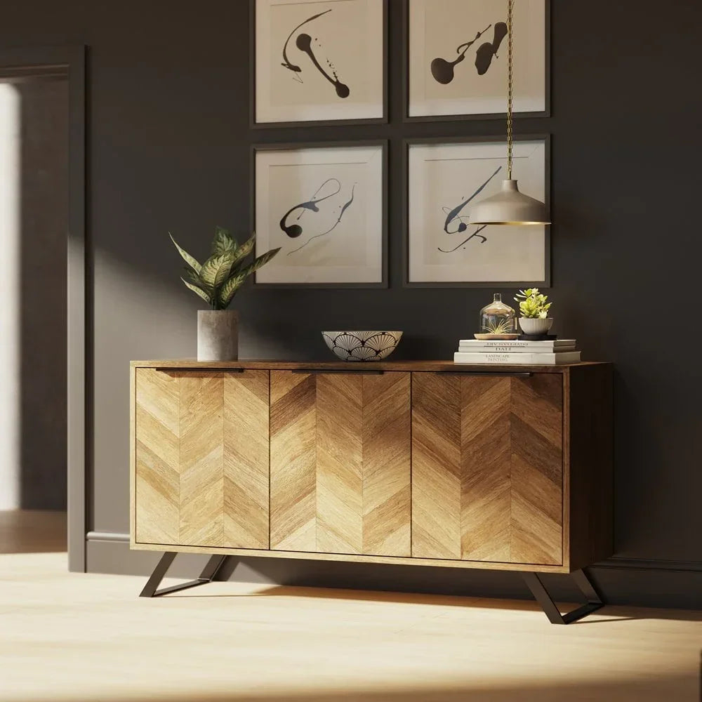 Chevron wood sideboard with metal legs in modern living room, decorative plants and wall art