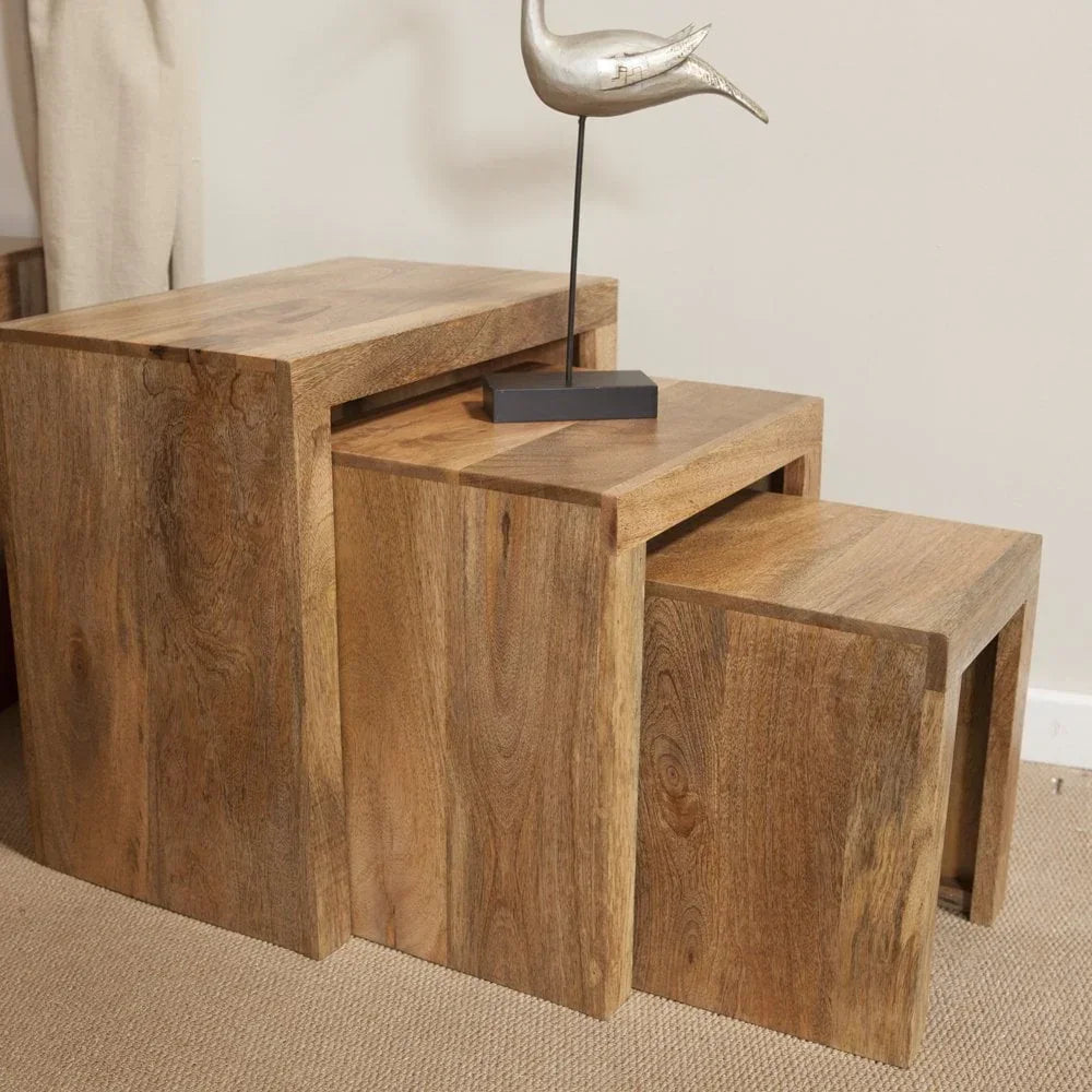 Solid wood nesting tables set with natural finish, styled with metal bird ornament