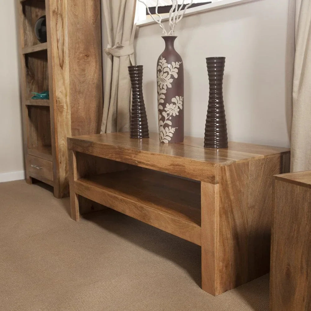 Solid wood coffee table with shelf and vases in a living room setting