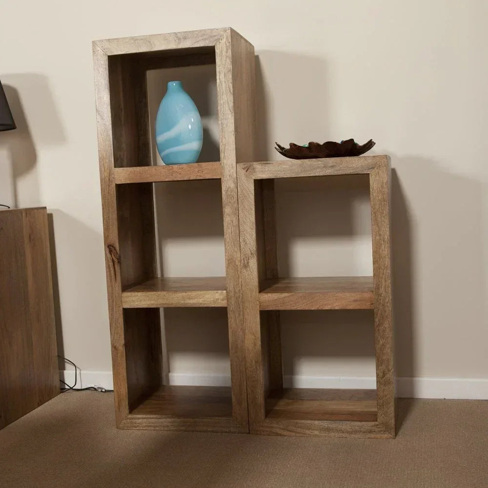 Solid wood display shelf unit with open cube shelves, styled with a blue vase and bowl